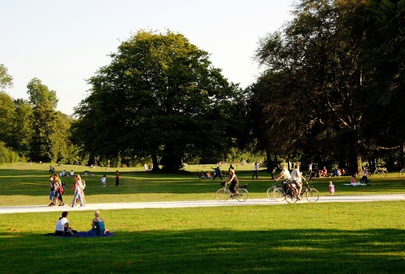 People relaxing and biking in a nearby park